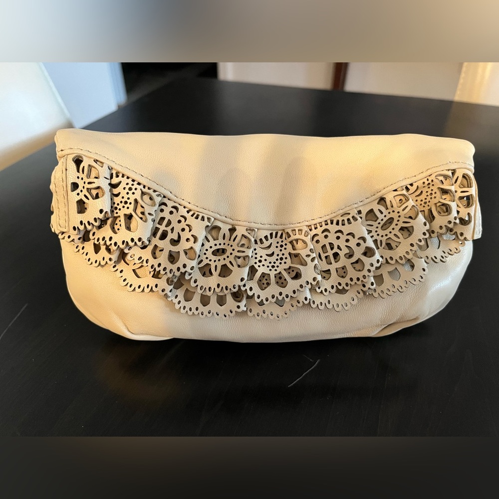 Ivory leather clutch, with eyelet trim, from Henri Bendel